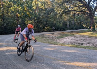 Cycling In Houston - NWCC Recent Activities Gallery 205 Cyclists riding on scenic wooded road during a Northwest Cycling Club event.