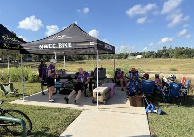 Cycling In Houston - NWCC Recent Activities Gallery 216 Ultralight cycling team resting at NWCC outdoor event under canopy in Oregon.
