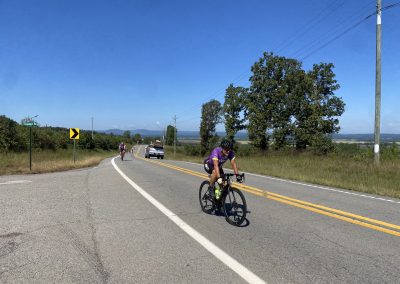 Cycling In Houston - NWCC Recent Activities Gallery 187 Cyclist riding on rural road with scenic landscape, part of Northwest Cycling Club activities.