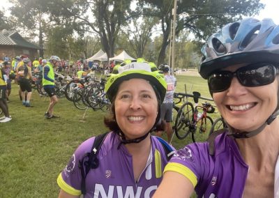 Cycling In Houston - NWCC Recent Activities Gallery 190 Cyclists smiling at Northwest Cycling Club event in purple jerseys with helmets and bikes.