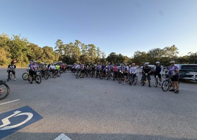 Cycling In Houston - NWCC Recent Activities Gallery 184 Group of cyclists with Northwest Cycling Club members preparing for a ride in a parking lot, promoting cycling community and fitness.