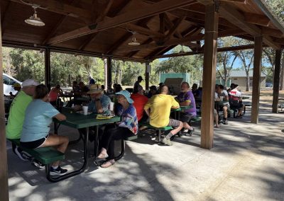 Cycling In Houston - NWCC Recent Activities Gallery 147 Outdoor picnic shelter at Northwest Cycling Club event with cyclists resting and socializing.