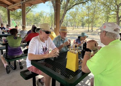 Cycling In Houston - NWCC Recent Activities Gallery 157 Comfortable seniors enjoying a social gathering at the Northwest Cycling Club event, outdoors in a park setting.