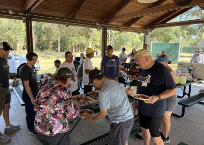 Cycling In Houston - NWCC Recent Activities Gallery 172 Group of cyclists at NWCC biking event enjoying outdoor meal.