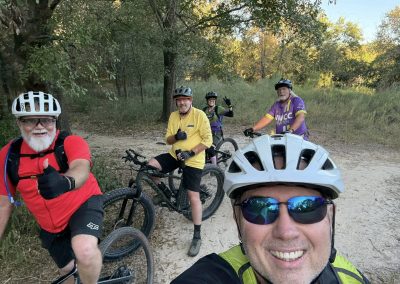 Cycling In Houston - NWCC Recent Activities Gallery 178 Group of cyclists enjoying trail riding with Northwest Cycling Club in a wooded area, promoting outdoor biking adventures.