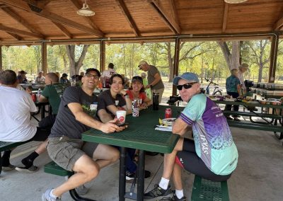 Cycling In Houston - NWCC Recent Activities Gallery 149 Outdoor picnic at Northwest Cycling Club event, cyclists enjoying rest and socializing.
