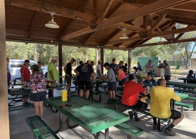 Cycling In Houston - NWCC Recent Activities Gallery 169 People enjoying a picnic at Northwest Cycling Club outdoor shelter after a bike ride.