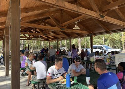 Cycling In Houston - NWCC Recent Activities Gallery 142 Vibrant group of cyclists enjoying a break at Northwest Cycling Club outdoor pavilion.