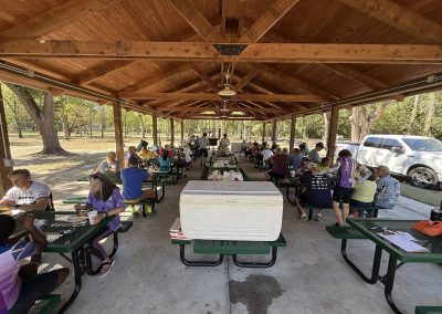 Cycling In Houston - NWCC Recent Activities Gallery 138 Outdoor cycling club event at a pavilion with cyclists enjoying a break in the park.