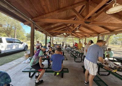 Cycling In Houston - NWCC Recent Activities Gallery 166 Outdoor cycling club gathering at a picnic shelter with people enjoying food after a ride.