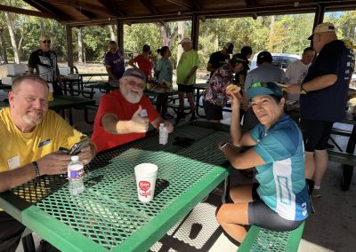 Cycling In Houston - NWCC Recent Activities Gallery 170 Enjoying rest and snacks at Northwest Cycling Club bike event in a shaded outdoor pavilion.