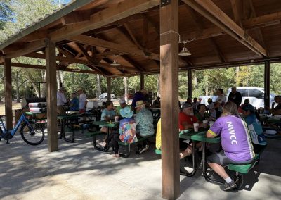 Cycling In Houston - NWCC Recent Activities Gallery 146 1. Group of cyclists at Northwest Cycling Club event in shaded outdoor pavilion.