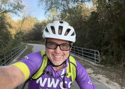 Cycling In Houston - NWCC Recent Activities Gallery 135 Man cycling on scenic trail with Northwest Cycling Club gear, enjoying outdoor bike riding.