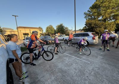 Cycling In Houston - NWCC Recent Activities Gallery 133 Cycling group preparing for ride at Northwest Cycling Club parking lot, outdoor bike event.