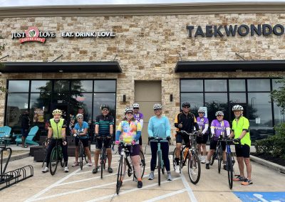 Cycling In Houston - NWCC Recent Activities Gallery 110 Group of cyclists outside NWCC bike club, ready for a ride, promoting community and cycling events.