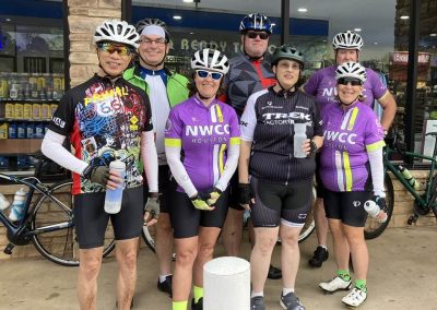 Cycling In Houston - NWCC Recent Activities Gallery 109 Cycling group members of Northwest Cycling Club in colorful jerseys and helmets at a meetup.