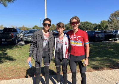 Cycling In Houston - NWCC Recent Activities Gallery 104 Young cyclist team members smiling after a race, wearing cycling gear and sunglasses outdoors.