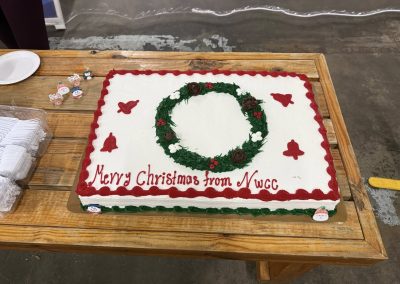 Cycling In Houston - NWCC Recent Activities Gallery 55 Festive Christmas cake with NWCC logo, holiday decorations, and cheerful message from Northwest Cycling Club.