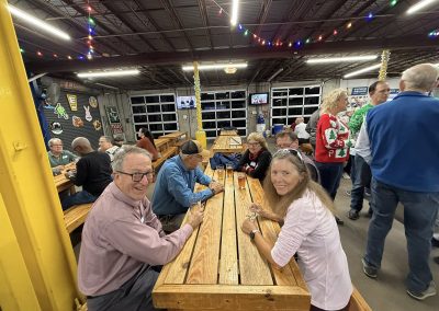 Cycling In Houston - NWCC Recent Activities Gallery 67 Happy cyclists gathering at Northwest Cycling Club event during a festive evening at a brewery or social venue.
