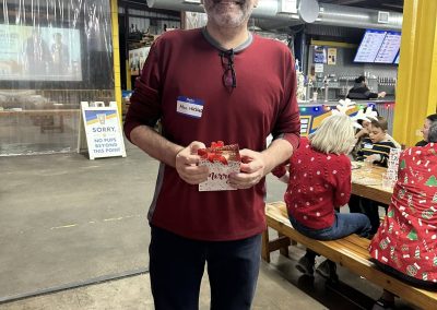 Cycling In Houston - NWCC Recent Activities Gallery 49 Friendly cyclist holding a holiday gift at Northwest Cycling Club event.