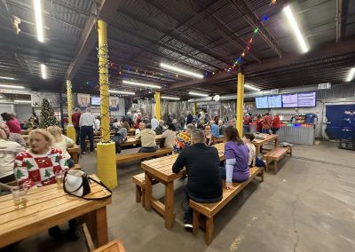 Cycling In Houston - NWCC Recent Activities Gallery 78 Indoor cycling club event with people socializing and celebrating, decorated for the holidays, in a vibrant community atmosphere.