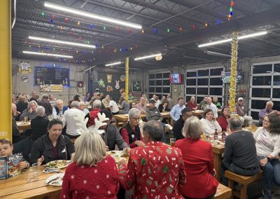 Cycling In Houston - NWCC Recent Activities Gallery 97 Seasoned cyclists celebrating holiday event at Northwest Cycling Club beer hall with festive decorations.