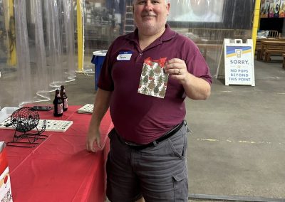 Cycling In Houston - NWCC Recent Activities Gallery 51 Friendly man holding Christmas gift at Northwest Cycling Club event.