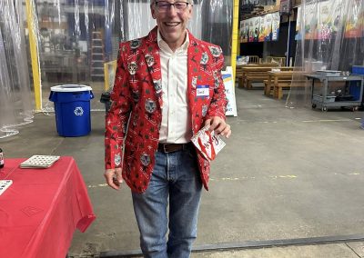 Cycling In Houston - NWCC Recent Activities Gallery 48 Festive man in holiday-themed blazer smiling at Northwest Cycling Club event.