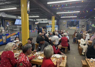 Cycling In Houston - NWCC Recent Activities Gallery 99 Vibrant indoor gathering of Northwest Cycling Club members celebrating with festive holiday cheer and socializing.