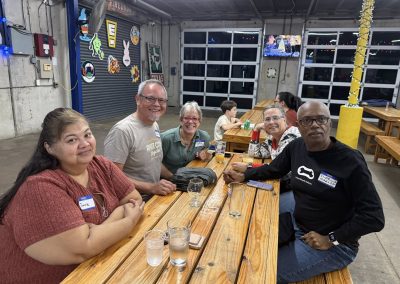 Cycling In Houston - NWCC Recent Activities Gallery 68 Group of cyclists enjoying social time at Northwest Cycling Club event, showcasing community and camaraderie.