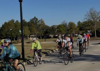 Cycling In Houston - NWCC Recent Activities Gallery 29 Group of cyclists riding together during a Northwest Cycling Club event in a park.