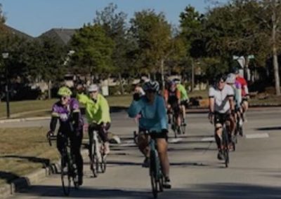 Cycling In Houston - NWCC Recent Activities Gallery 31 Group of cyclists riding together during a bike ride in a park setting.